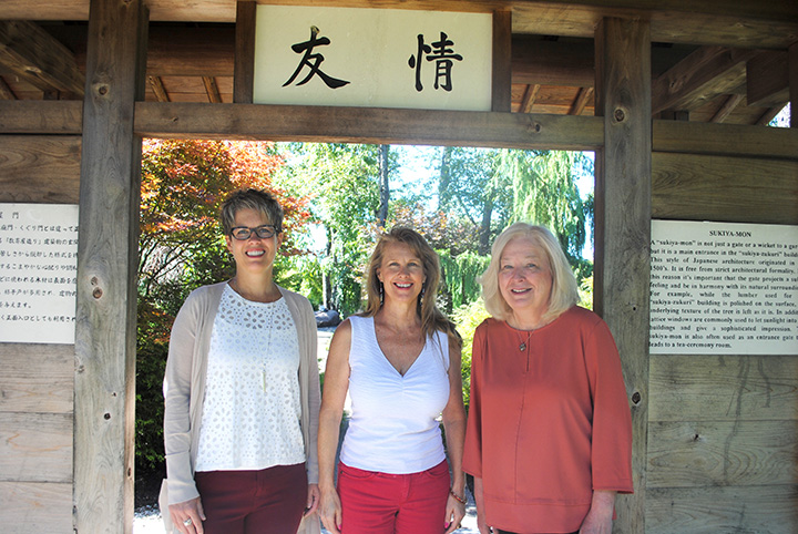From left, Dawn Fraley, Lynda Pitz and Rosemary Waters in the entry gate that was donated to Carmel from Kawachinagano, Japan. (Photo by Anna Skinner)