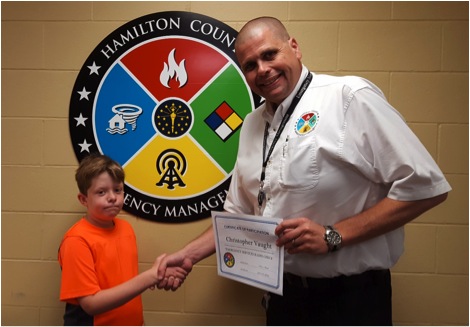 Christopher Vaught, 12, of Fishers and Heritage Christian School student, recently participated in an emergency services radio check drill at the Hamilton County Emergency Operations Center with Emergency Management Deputy Director Carl Erickson. Participation in the drill helped Vaught earn the Boy Scout’s Emergency Preparedness merit badge. (Submitted photo)