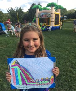 Bella Pappas presents her winning artwork at the Fall Festival. (Submitted photo)