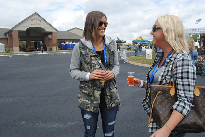Taylor Wilson, left, and Brittany Pavey chat over beer samples. (File photo)