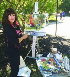 Beth Forst of Noblesville works on a painting during last year’s Carmel on Canvas. (File photo)