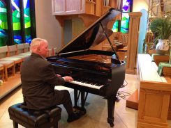 David Young with the Steinway B piano. (Submitted photo provided by the Saint Louis de Montfort Catholic Church.) 