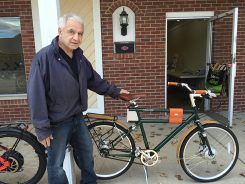 Accent Bicycles owner David Tortora with an electric bike. (Photo by Mark Ambrogi)