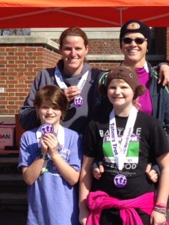 Melanie Brown, back left, her partner, Amy Harbin, and her daughters, Tatum Brown and Ahni Brown Harbin, display their medals after the 2015 Tatum’s Trot 5K. “Everyone else in my family hates to run, so it was really cool that they did this,” Melanie Brown said. (Submitted photos) 