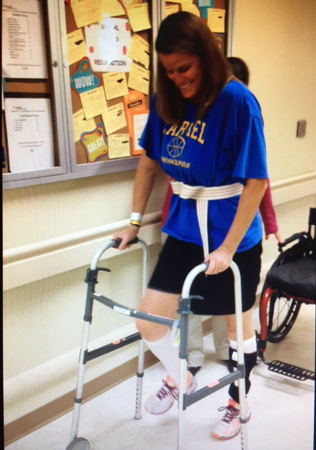 Melanie Brown uses a walker to relearn how to walk after being paralyzed by transverse myelitis in 2014.