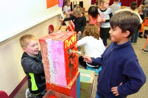 Caesar Hart, 6, a first grader, plays the “Pacman” arcade game, created by third graders Jackson Orr and Caleb Ashley, pictured left. 