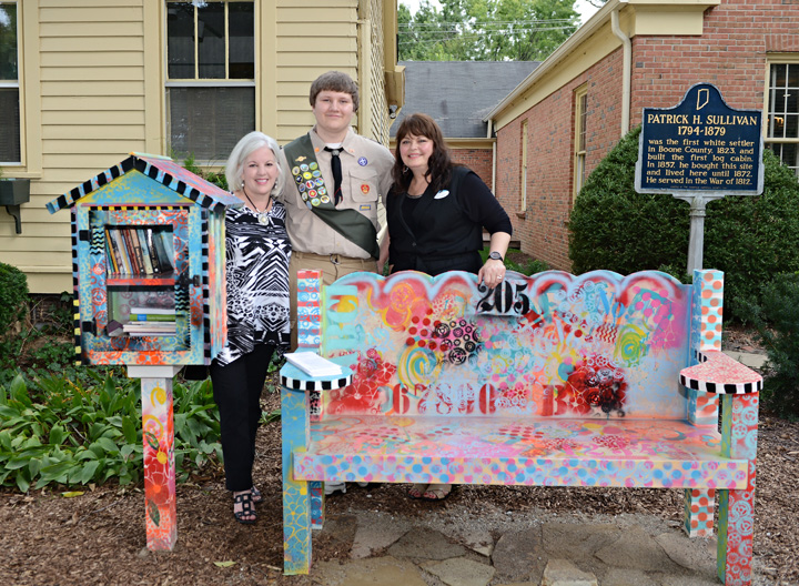 From left, Susan Albers, Skyler Keifer and Cynthia Young pause near the new Little Free Library and reading bench at the SullivanMunce Cultural Center. (Photo by Theresa Skutt)