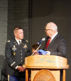 Army vet David Kinyon is presented with a Carmel Greyhounds shirt by CHS Principal John Williams. (Submitted photo) 