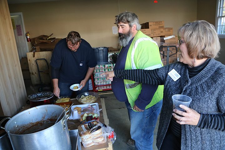 From right, Karen McTaggart, CUMC membership secretary, points out lunch options to Roy Bailes, Jr. and Jacob Farr. (Photo by Ann Marie Shambaugh)