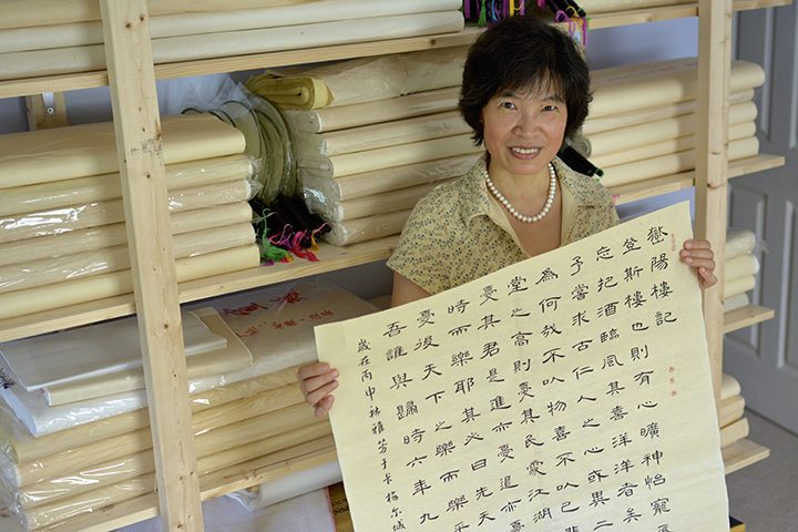 Jenny Feng displays her calligraphy in her Carmel home. (Photo by Lisa Price)