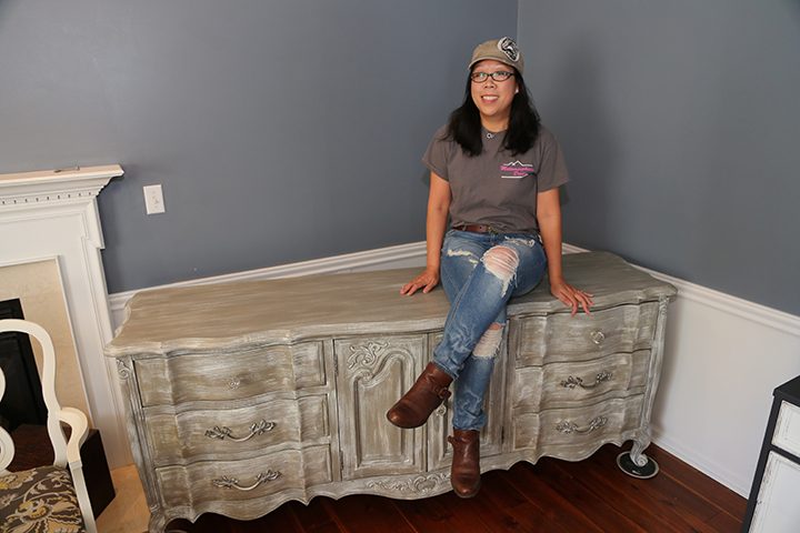 Meaghan Wolf rests on a piece of furniture she refinished in her Carmel home. (Photo by Ann Marie Shambaugh) 