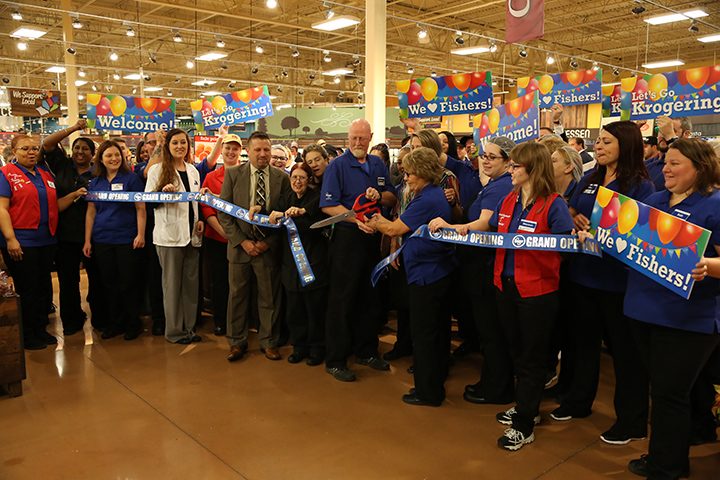 James Miles and Lavonda Slayton, center, cut the ribbon to the expanded Kroger at 116th Street and Olio Road. (Submitted photo)