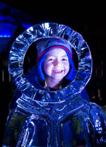 Colton McClain peers through one of the ice sculptures at last year’s Frost Fest.