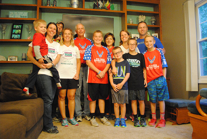 Jim Lathrop (back, center) with his family. His daughters and grandchildren have followed in his footsteps when it comes to running. (Photo by Anna Skinner)