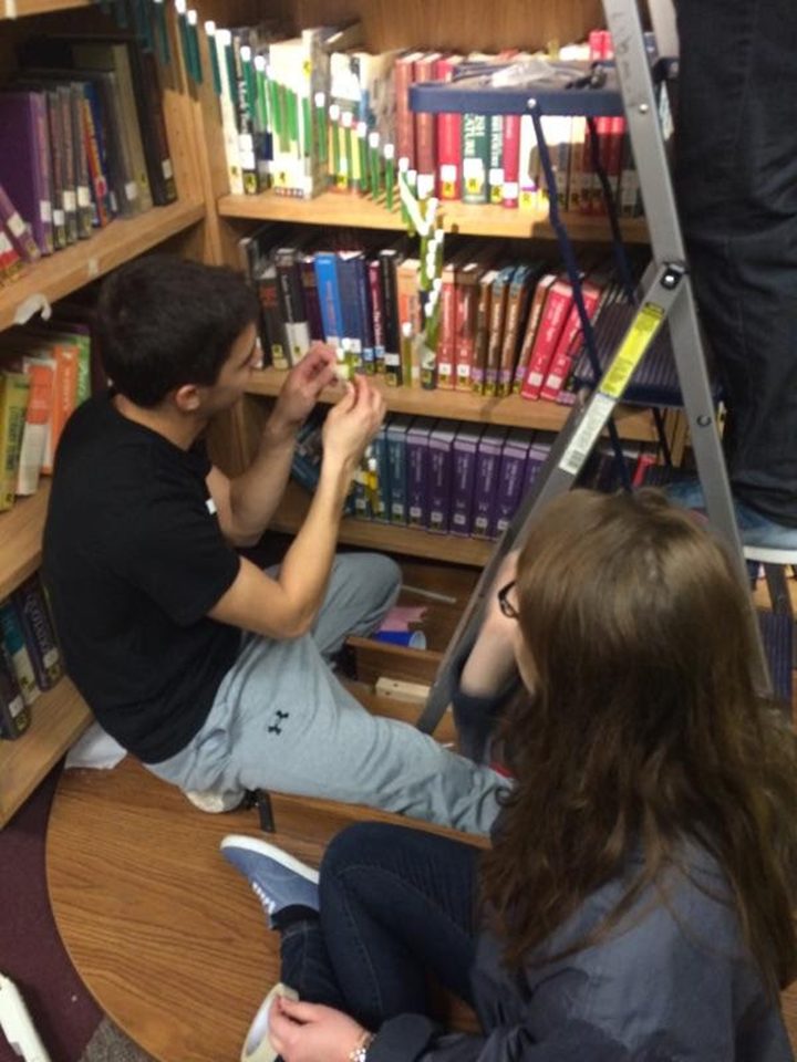 Sharon Hoffman and Justin Mamaril construct a chandelier out of test tubes to follow the Fibonacci spiral and hung it in the Westfield High School library. (Submitted photo)