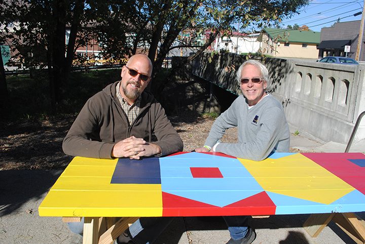 Jon Edwards, left, and Chris Blice at the Love is Primary picnic table. (Photo by Anna Skinner)