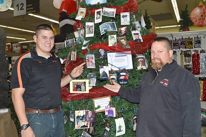 Joe Hollingsworth, Jr., and Joe Hollingsworth point out photos on the veterans tree. (Submitted photo)