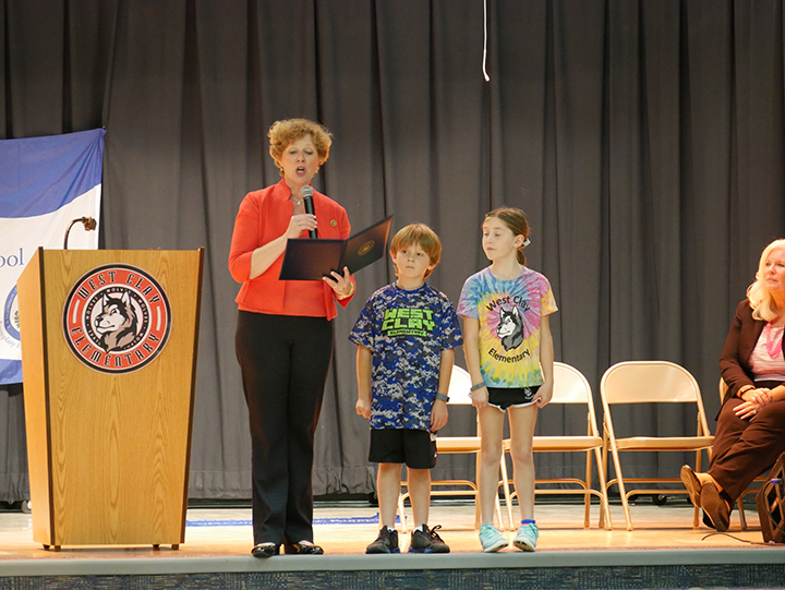 U.S. Rep. Susan Brooks reads the Congressional Record honoring West Clay’s accomplishment as students Reese Blanchard and Jake Gardner look on. (Submitted photo) 