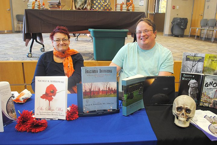 Last month, the Hamilton East Public Library in Fishers hosted Booktoberfest, which featured many local authors selling work and answering questions from the community. Nicole and Michael Kobrowski, Westfield, pause at their booth. (Photo by Anna Skinner)