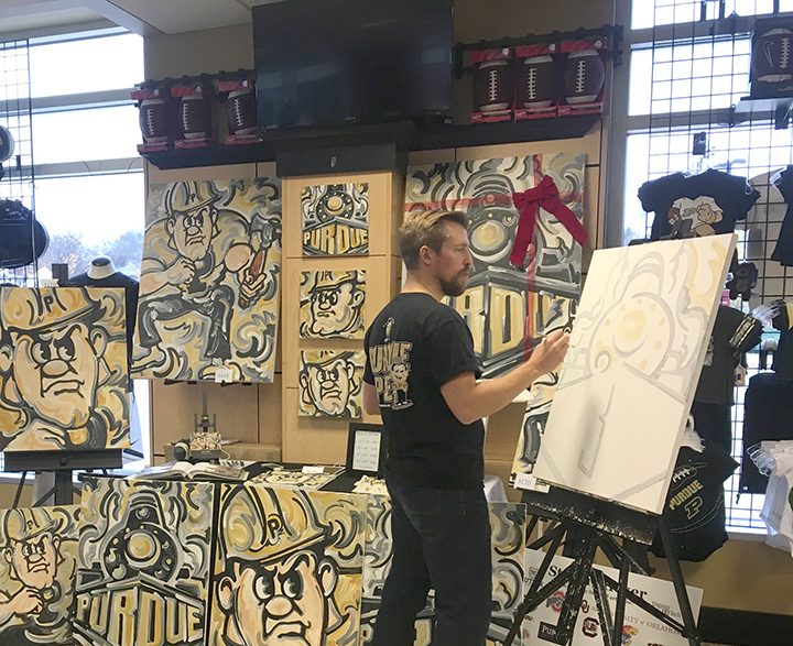 Justin Patten of Zionsville works on a Boilermakers painting at Purdue University. (Submitted photo)