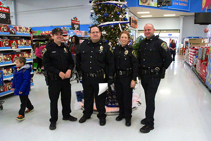 Four of LPD’s five Caroling Cops pause before performing at Walmart on Dec. 3. From left, they are Steve Fishburn, Jamon Jack, Diane Mack and Brian Robertson. Not pictured: Eric Trost. (Photo by Sadie Hunter)