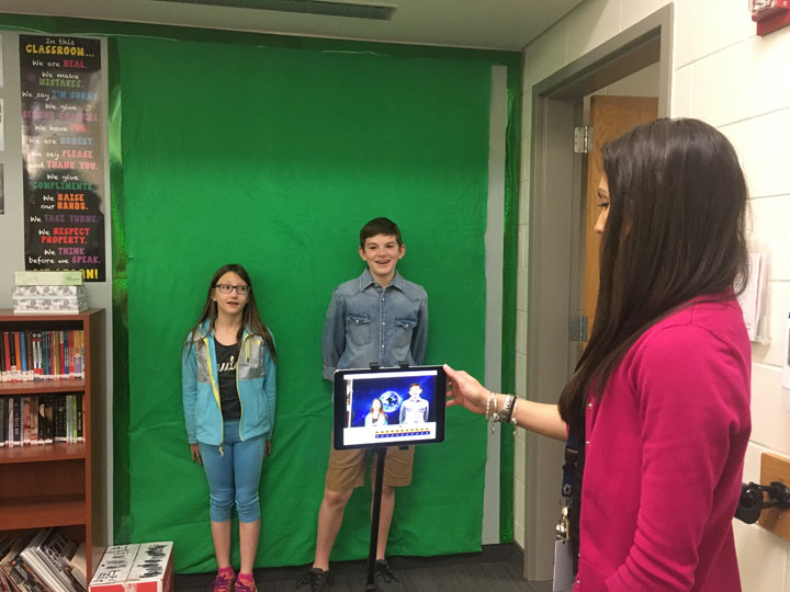 Towne Meadow Elementary teacher Josie McKay helps students Audrey Nace and Cal Bostic use a green screen for a class project. (Submitted photo)
