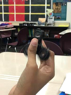 A student uses a fidget spinner during class at Clay Middle School. Fidgets are available in a variety of shapes, sizes and textures. (Submitted photo)