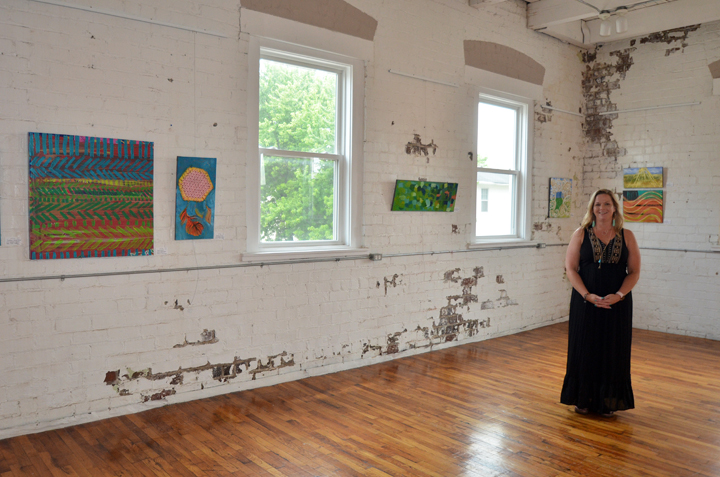 Salewicz in the main gallery at Sugar Creek Art Center, amongst her “Rural Routes” pieces. (Photo by Sara Baldwin)