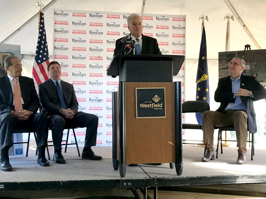 Mayor Andy Cook, center, speaks on Bastian Solutions announcement of a new manufacturing center to be built in Westfield. From left, Michael Romano, president of Toyota Advanced Logistics; Bill Bastian II of Bastian Solutions, Mayor Andy Cook and Gov. Eric Holcomb. (Photo by Anna Skinner)