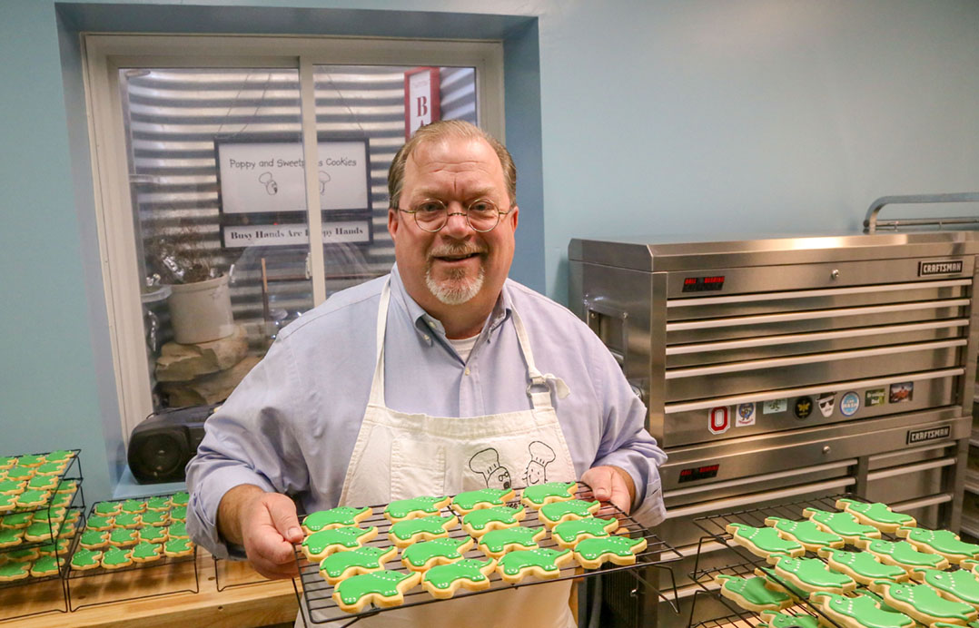 Dave Sanders displays custom sugar-cookies he baked and decorated in the commercial kitchen in his Carmel home. (Photo by Ann Marie Shambaugh) 