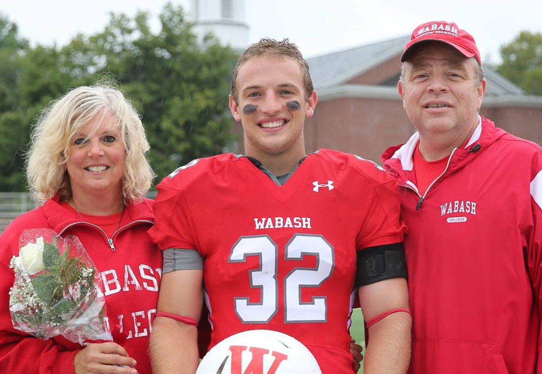 Evan Hansen, center, pauses with his mother, Mary, and father, Chuck, Sept. 8 at Wabash College’s senior day, two days before he took his life. (Submitted photo) 