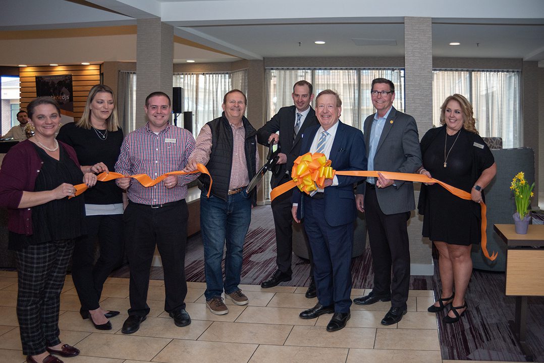 Courtyard by Marriott General Manager Patrick Durbin cuts the ribbon April 24 to celebrate renovations at the hotel at 37 W. 103rd St. Updates include new furniture, carpet and wall coverings throughout the hotel.