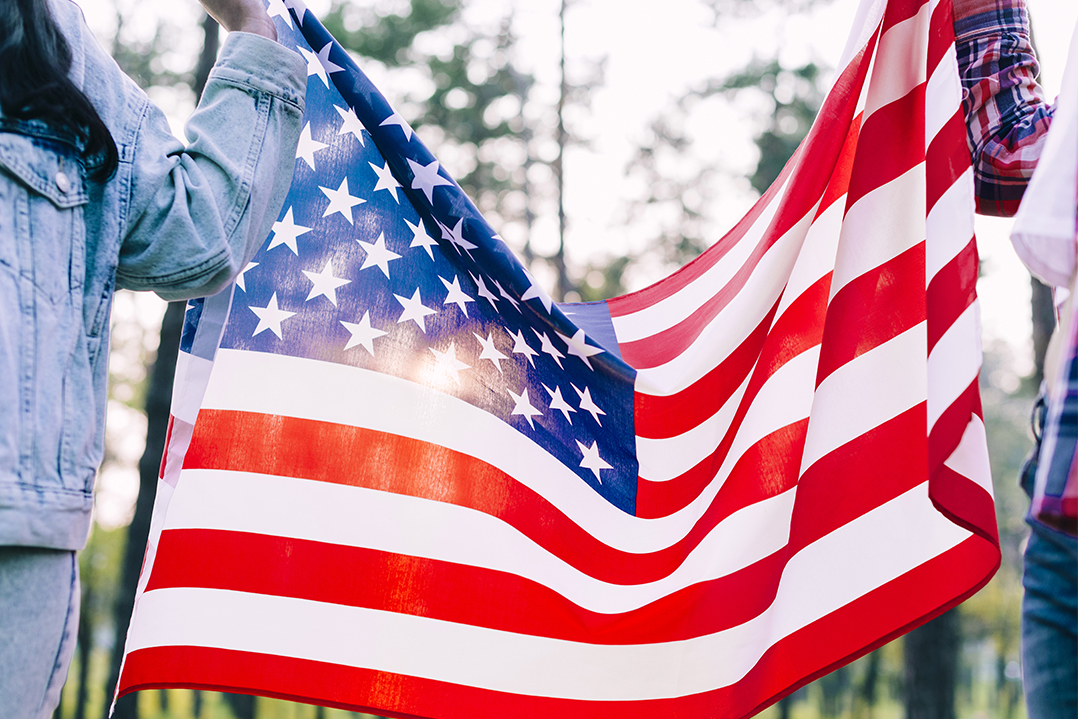 people holding flag usa park